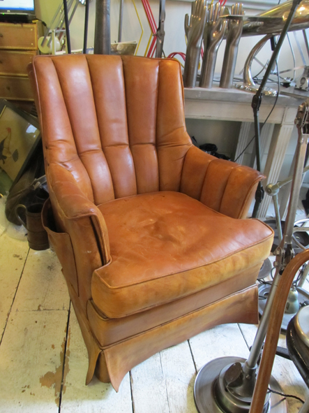 A leather Holland chair with a storage pocket on side.